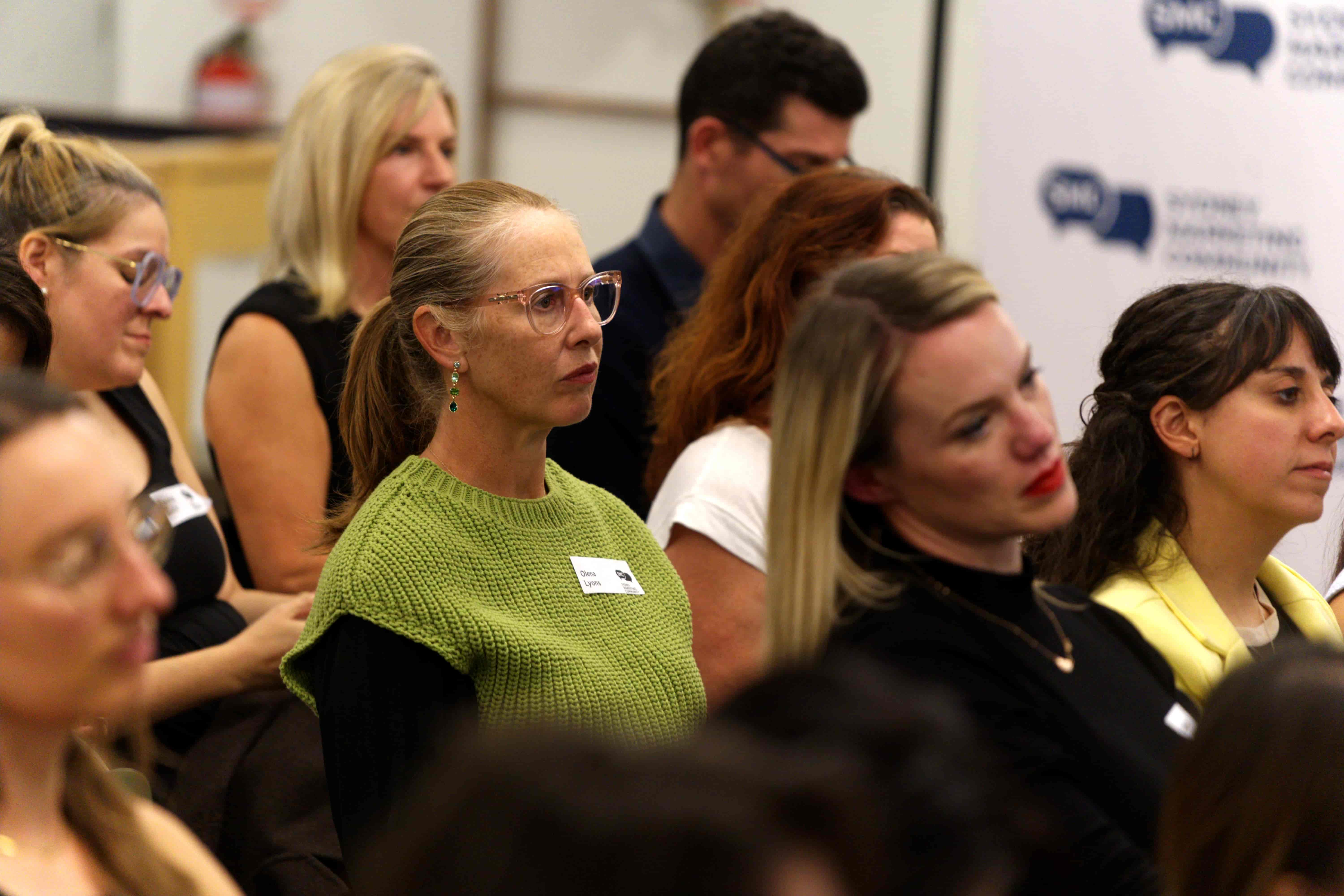A group of people listening to a presentation