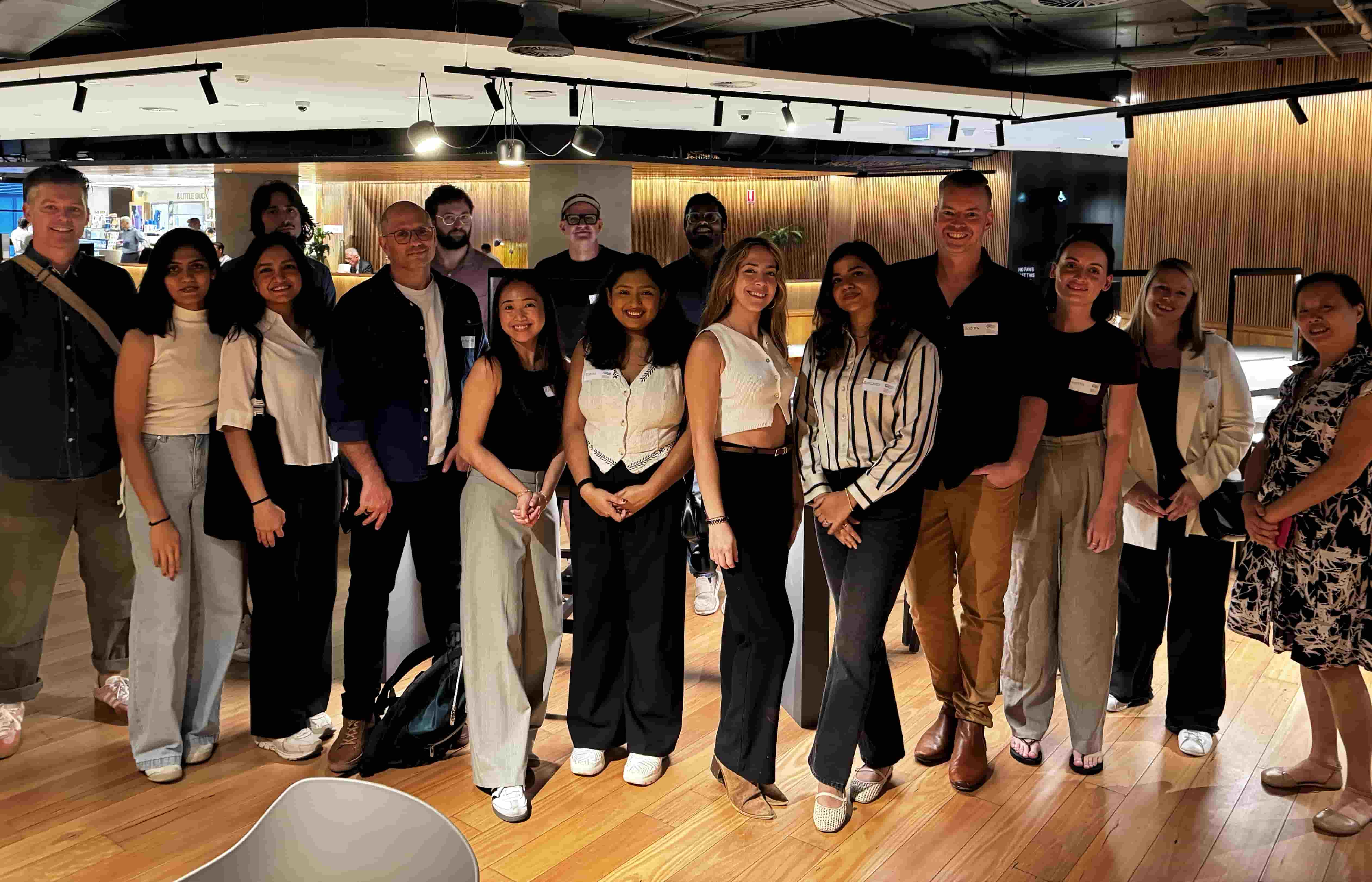A group of people standing in a rough line. All have name tags